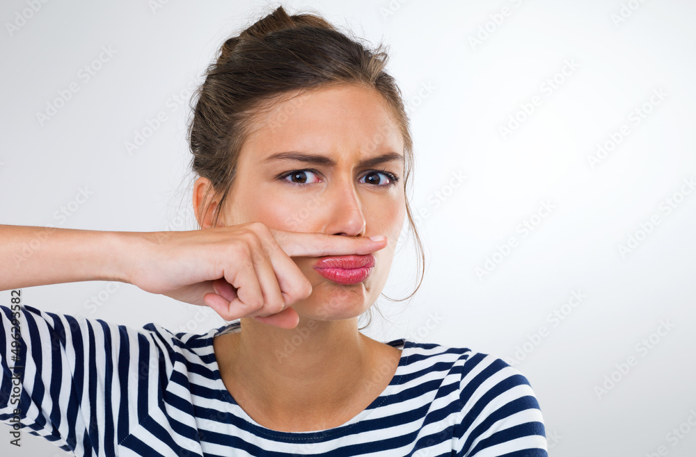 Theyll never find me with this disguise. Portrait of a beautiful young woman using her finger to make a moustache. Theyll never find me with this disguise. Portrait of a beautiful young woman using her finger to make a moustache.