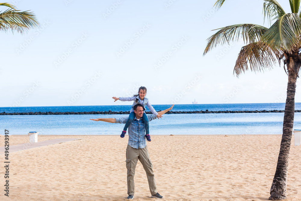 beautiful family on a tropical beach with palm tree during summer vacation beautiful family on a tropical beach with palm tree during summer vacation