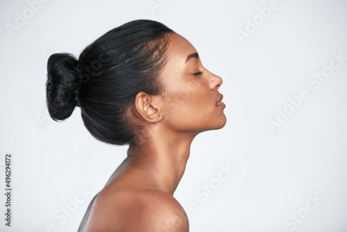 The glow comes from within. Shot of a beautiful young woman posing against a white background.