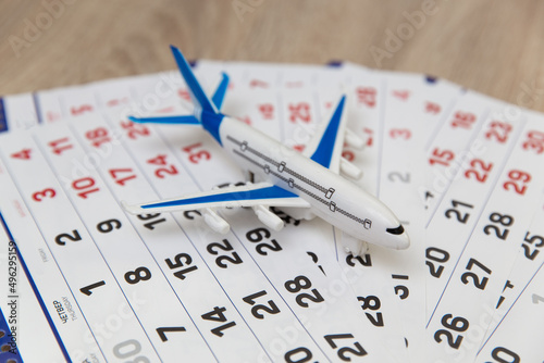 Paper Calendar with air plane on table. Travel concept. © splitov27