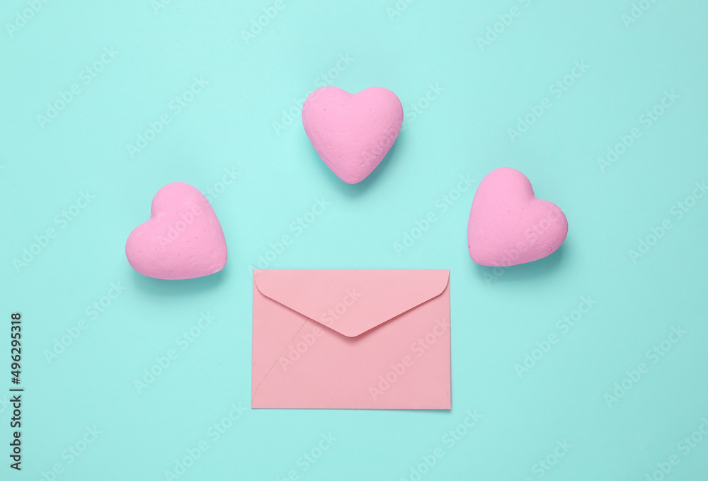 Envelope with hearts on blue background. Love concept. Top view