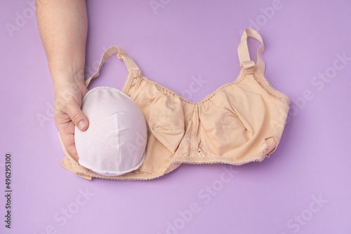 Breast prosthesis before inserting it into the special bra. Breast prosthesis and post surgery bra for breast cancer patient after mastectomy photo