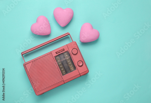 Retro fm radio receiver with hearts on blue background. Romantic melody. Top view