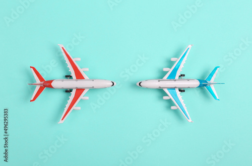 Two Toy model airplanes on blue background. Travel concept. Flat lay, top view