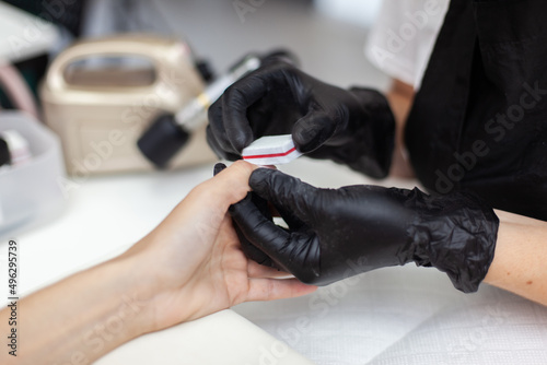 Manicurist workflow with client's nails. Nail care, manicure © splitov27