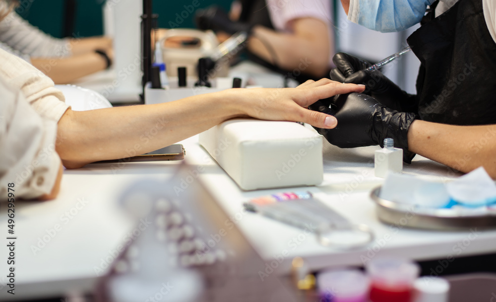 Manicurist workflow with client's nails. Nail care, manicure Manicurist workflow with client's nails. Nail care, manicure