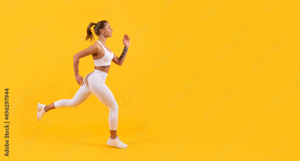 sport woman runner running on yellow background. copy space