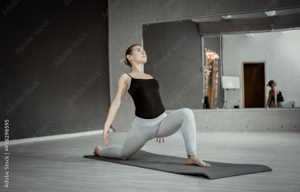 Young yogi attractive woman practicing yoga hatha. Doing indoor yoga on the mat. Healthy lifestyle. Young yogi attractive woman practicing yoga hatha. Doing indoor yoga on the mat. Healthy lifestyle.