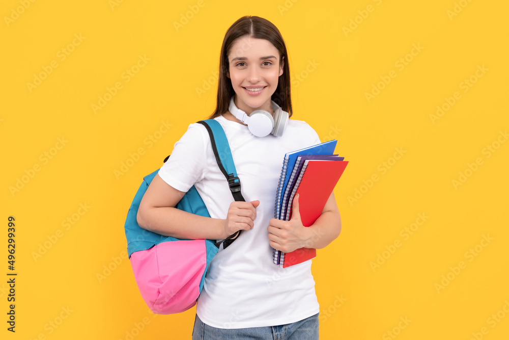 Fototapeta premium smiling lady in headphones hold copybook carry backpack, knowledge