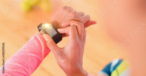 Light spot against close up of person using a smartwatch