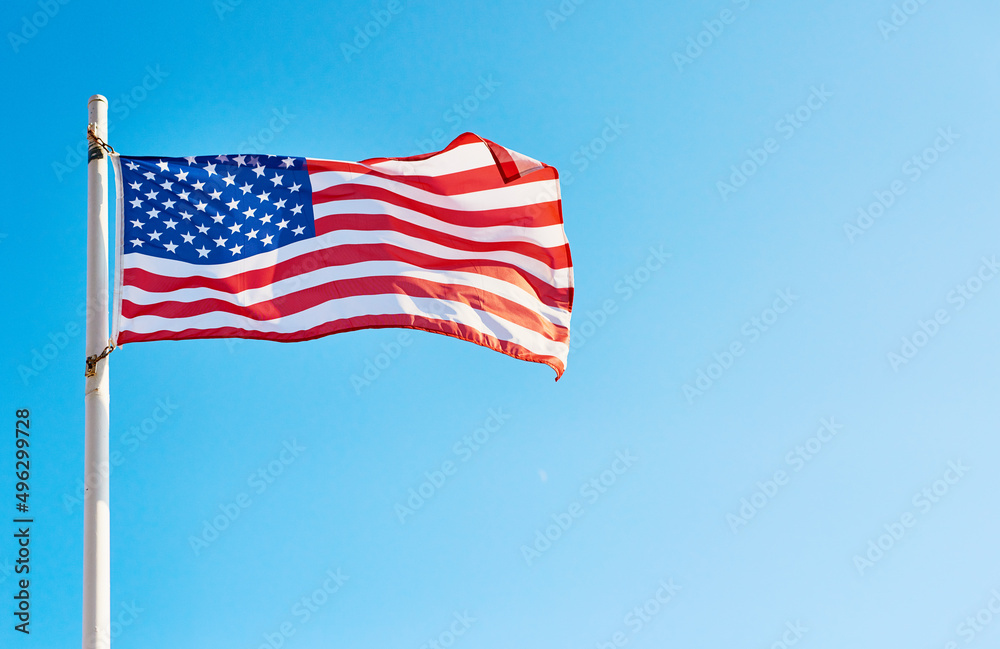 I pledge allegiance to the flag. Low angle shot of the American flag standing on its own outside during the day.