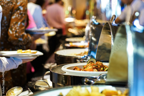 People hand grab buffet food serve in hotel restaurant