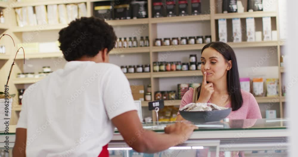 Animation of happy biracial woman trying diverse food at store Animation of happy biracial woman trying diverse food at store