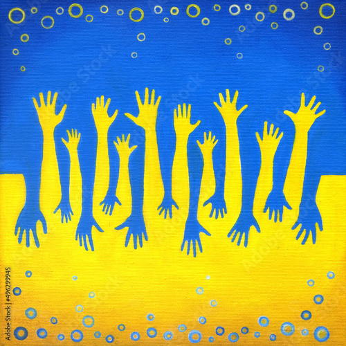 Le mani gialle e blu sulla bandiera ucraina, saluto in guerra	 photo