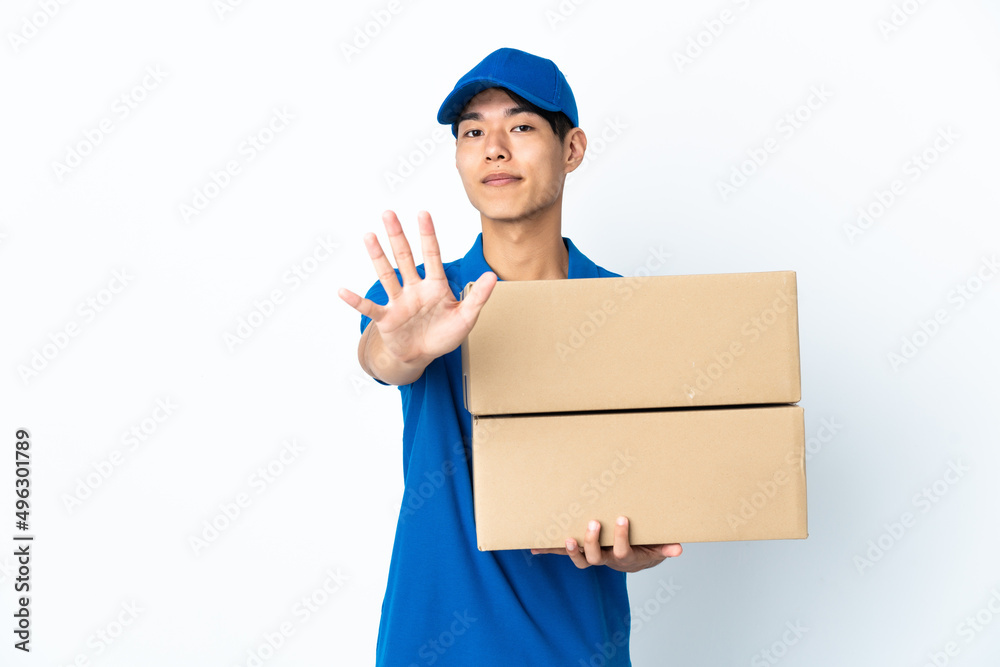 Delivery Chinese man isolated on white background counting five with fingers Delivery Chinese man isolated on white background counting five with fingers