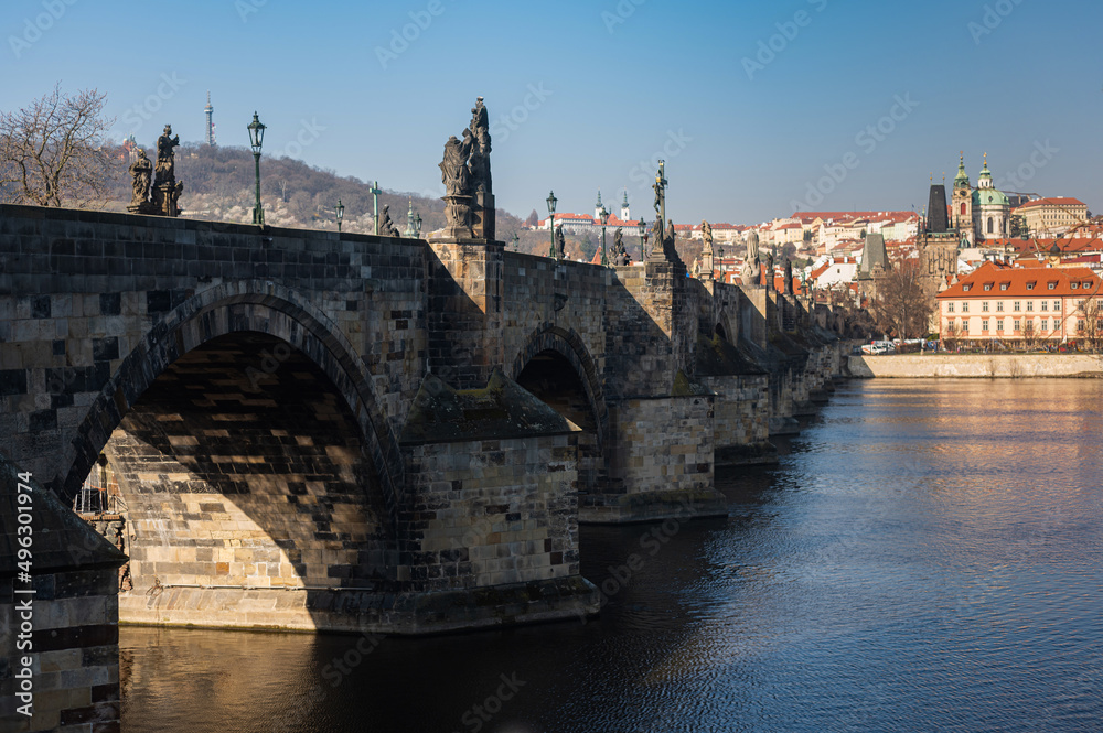 Beautiful view of the Charles Bridge in Prague, Czech Republic at the end of March. Cold sunny spring.