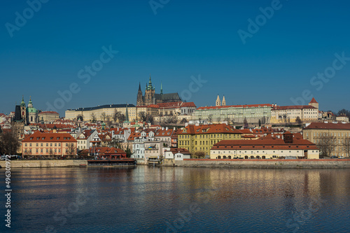 Old town of Prague. Czech Republic over the Vltava River with St. Vitus Cathedral on the horizon. Bright sunny day blue sky.