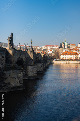 Beautiful view of the Charles Bridge in Prague, Czech Republic at the end of March. Cold sunny spring.