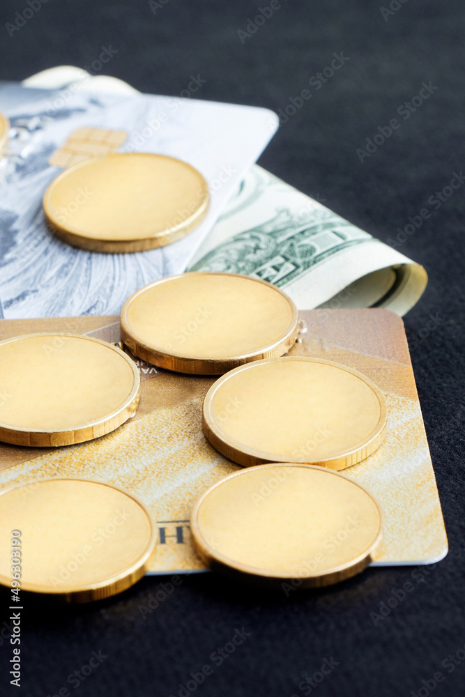Credit card and coins on a black backround.Selective focus. Copy space. Vertical orientation Credit card and coins on a black backround.Selective focus. Copy space. Vertical orientation