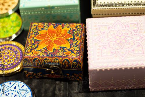 handmade boxes on the counter at the fair. hand-painted national patterns