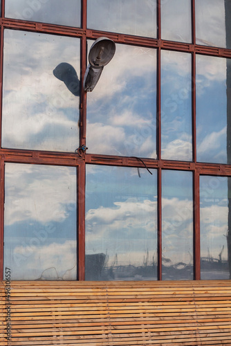 Texture of an old dirty factory windows with a lantern, industrial factory