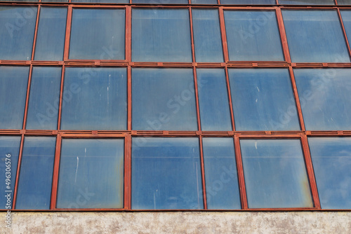 Texture of an old dirty factory windows with a lantern, industrial factory