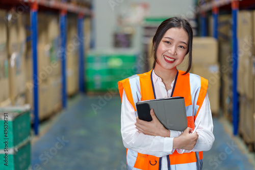 Warehouse manager with digital tablet.