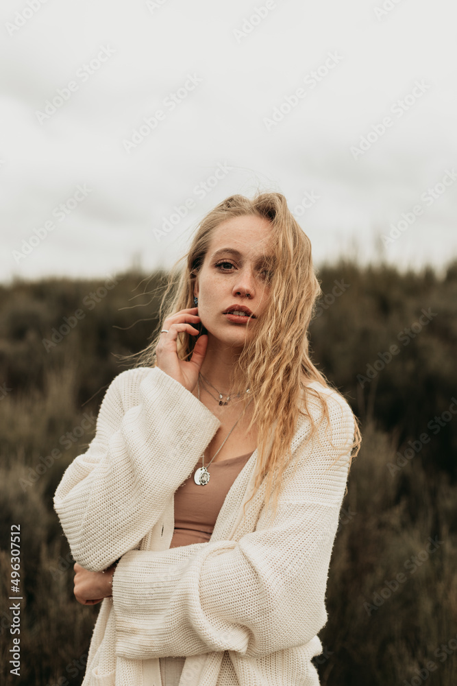 Woman standing on grassy field in countryside Woman standing on grassy field in countryside