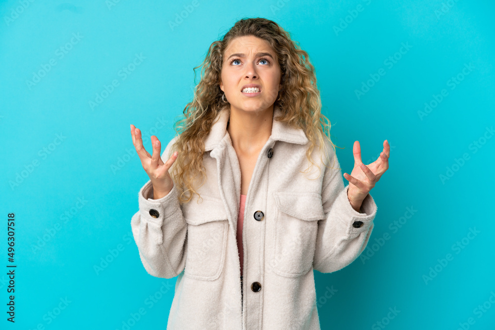 Young blonde woman isolated on blue background stressed overwhelmed Young blonde woman isolated on blue background stressed overwhelmed