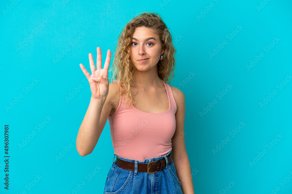 Young blonde woman isolated on blue background happy and counting four with fingers Young blonde woman isolated on blue background happy and counting four with fingers