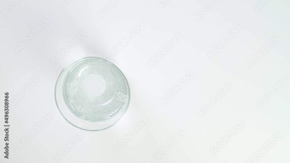Fizzy tablet in glass of water. water-soluble tablets close-up on a white background. Healthy vitamin tablet bubbling isolated. Close up sparkling water glass with dissolving effervescent aspirin pill Fizzy tablet in glass of water. water-soluble tablets close-up on a white background. Healthy vitamin tablet bubbling isolated. Close up sparkling water glass with dissolving effervescent aspirin pill