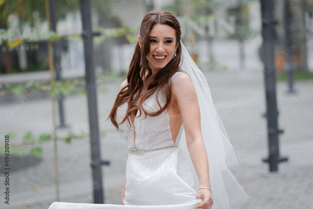 Charming young bride with a veil.