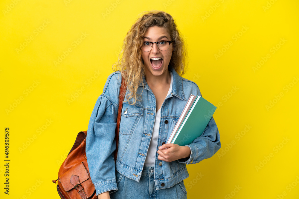 Young student caucasian woman isolated on yellow background with surprise facial expression Young student caucasian woman isolated on yellow background with surprise facial expression