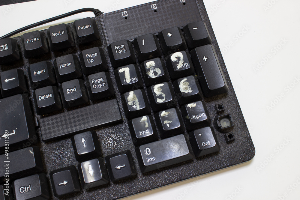 Broken keyboard. Painted numbers. Erased stickers on the buttons. Hard work concept Broken keyboard. Painted numbers. Erased stickers on the buttons. Hard work concept