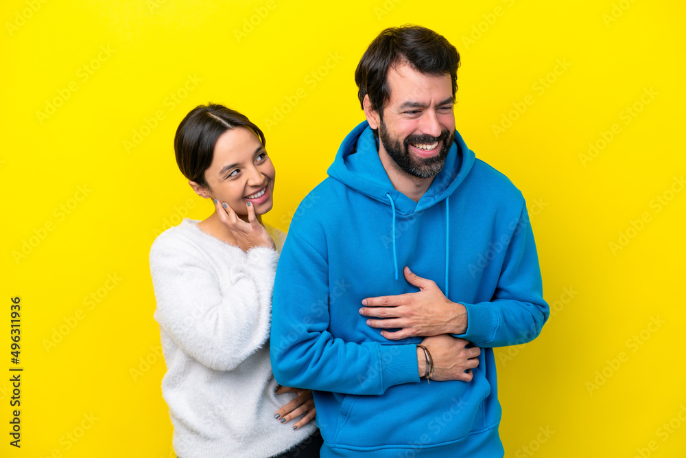Young caucasian couple isolated on yellow background smiling a lot Young caucasian couple isolated on yellow background smiling a lot