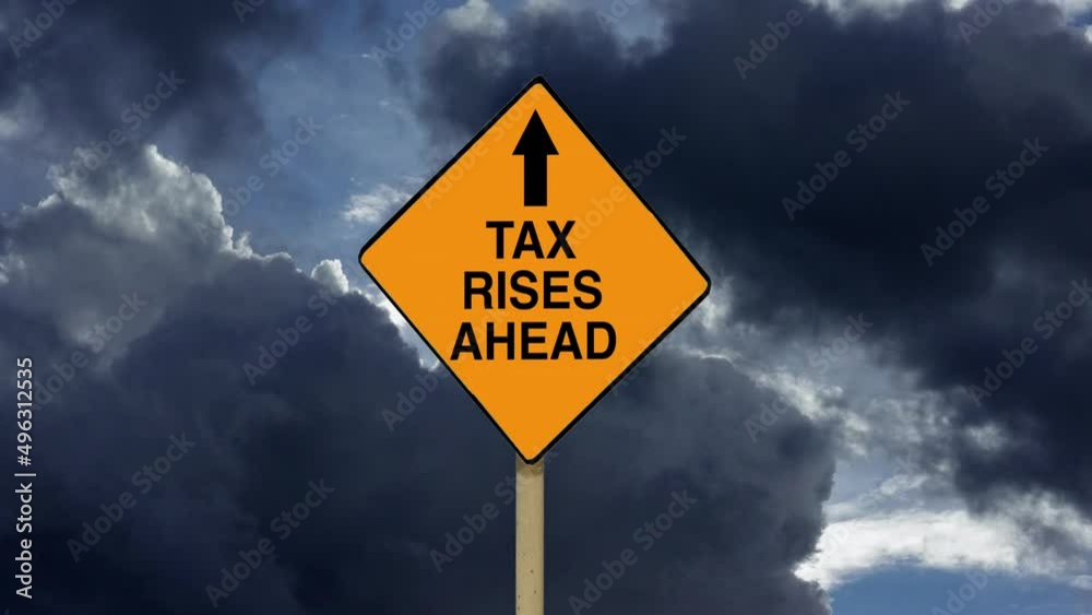 Money taxes and financial problems. Zoom into a Tax Rises Ahead road sign with timelapse clouds background.
