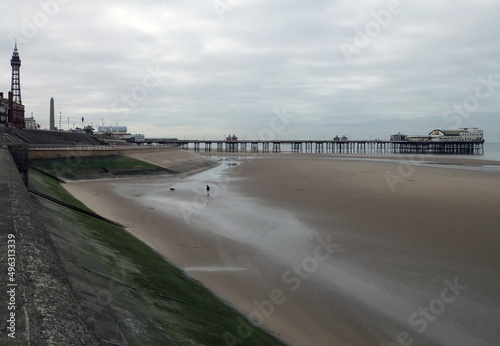 view of blackpool south pier and tower with beach at low tide with grey clouds