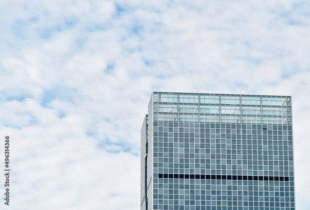 Modern office building against the cloudy sky Modern office building against the cloudy sky