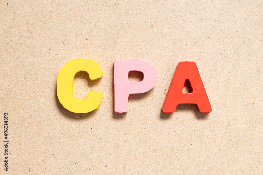 Color alphabet letter in word CPA (Abbreviation of Cost per click or Certified public accountant) on wood background