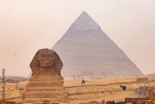 View of Sphinx in The Giza Plateau with The Great Pyramid of Giza in the background.