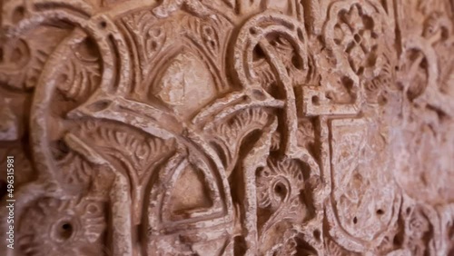 Gimbal shot of architecture wall details of Alhambra palace in Granada, Spain. Camera moving along wall decorated with moorish decor