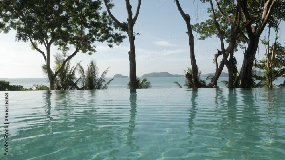 infinite swimming pool with background of natural sea and mountain view with some tree. vacation summer destination infinite swimming pool with background of natural sea and mountain view with some tree. vacation summer destination