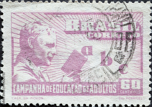 Brazil - circa 1949: a postage stamp from Brazil, showing a man with a book and the letters a, b, c. Campaign for adult literacy .