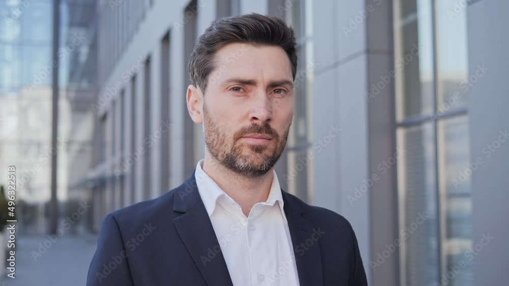 Portrait of confident businessman man turning head to camera and smiling while crossing arms proud entrepreneur enjoying successful startup company outside. Beautiful smile of a focused person. Portrait of confident businessman man turning head to camera and smiling while crossing arms proud entrepreneur enjoying successful startup company outside. Beautiful smile of a focused person.