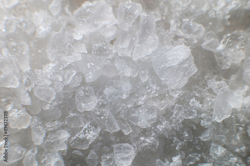 Macro view of crystals of table salt. Taste useful additive saline solutions background in shallow depth of field. Close-up