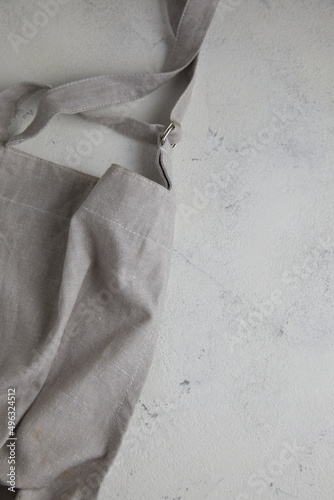 Apron on light rust textured background. Copy space.