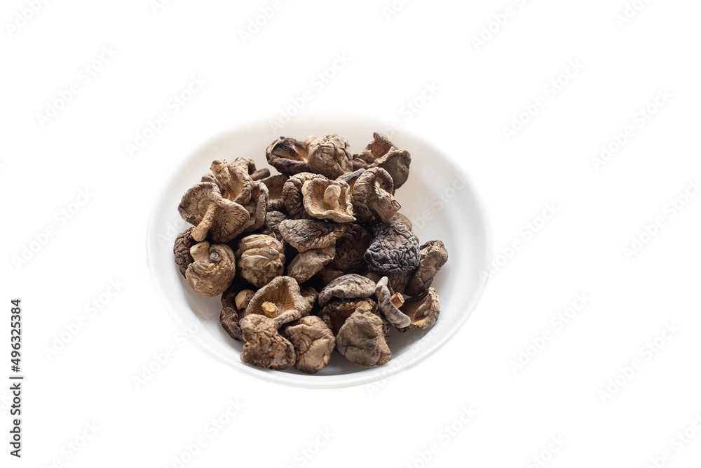 dried shiitake mushrooms in a plate on a white background dried shiitake mushrooms in a plate on a white background