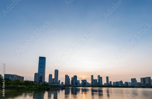 Office building reflected in the water at sunset