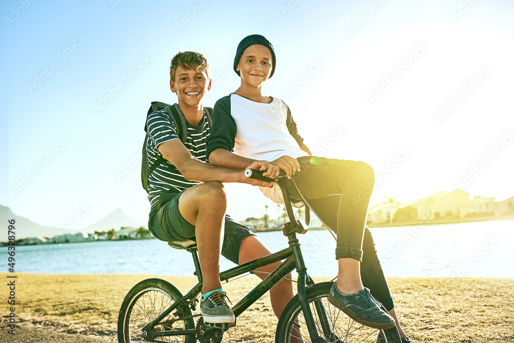 Taking my brother for a ride. Cropped portrait of a young boy giving his younger brother a lift on a bicycle outside. Taking my brother for a ride. Cropped portrait of a young boy giving his younger brother a lift on a bicycle outside.