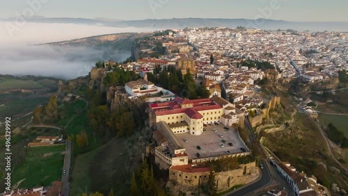 Great aerial morning view of Ronda, Spain with fog. Flying over houses and cathedral in Ronda, Andalusia